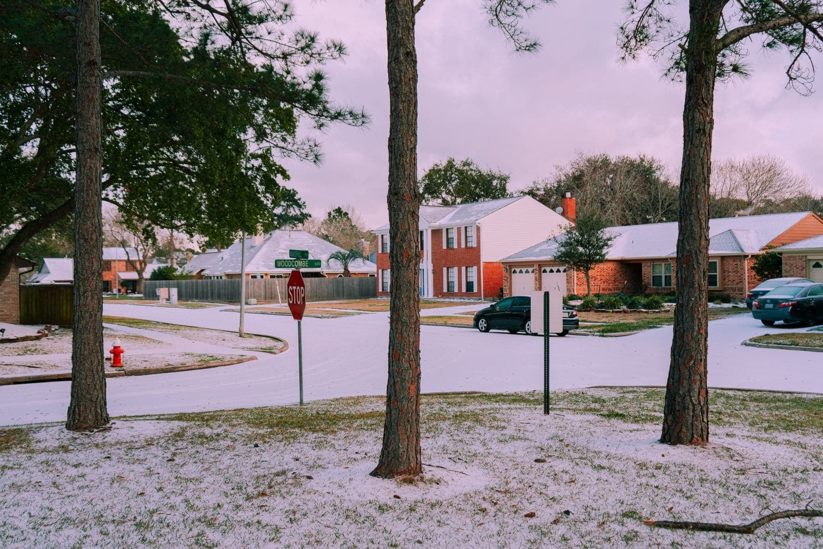 Snow covering yards and streets in a southern brick-home neighborhood