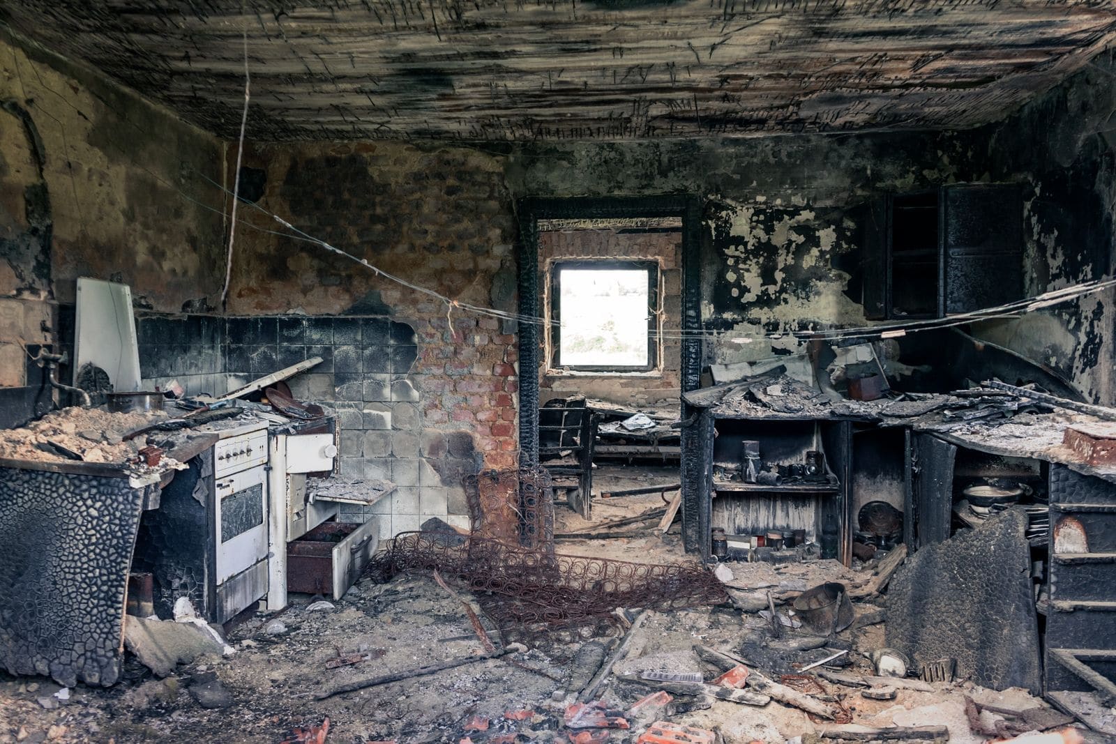 Kitchen interior blackened with soot after a house fire
